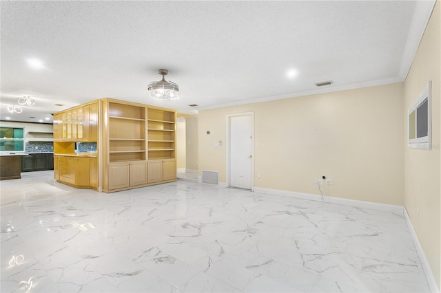 unfurnished living room featuring crown molding and a textured ceiling