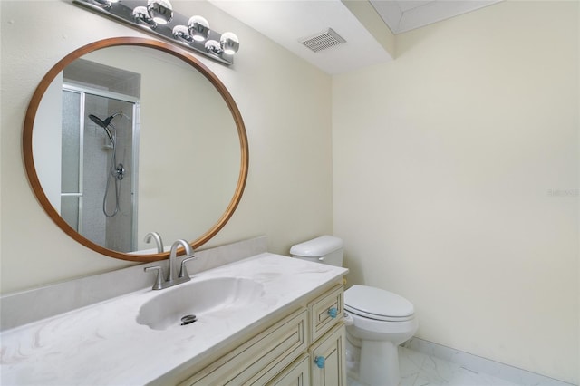 bathroom with vanity, a shower with shower door, and toilet