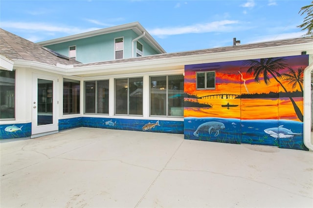 view of side of property with a patio