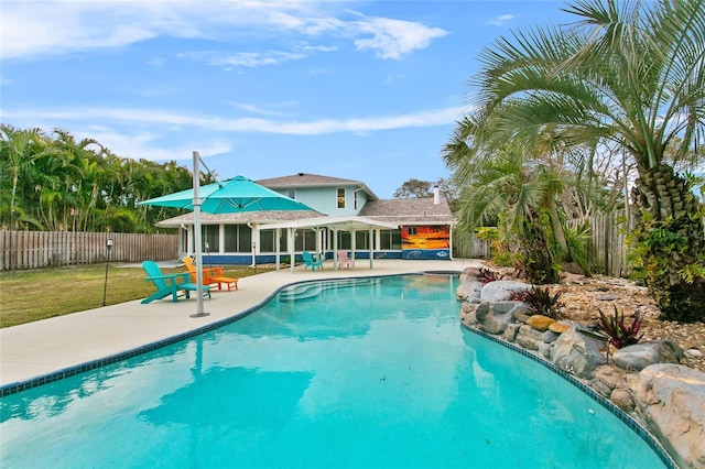 view of swimming pool featuring a yard and a patio