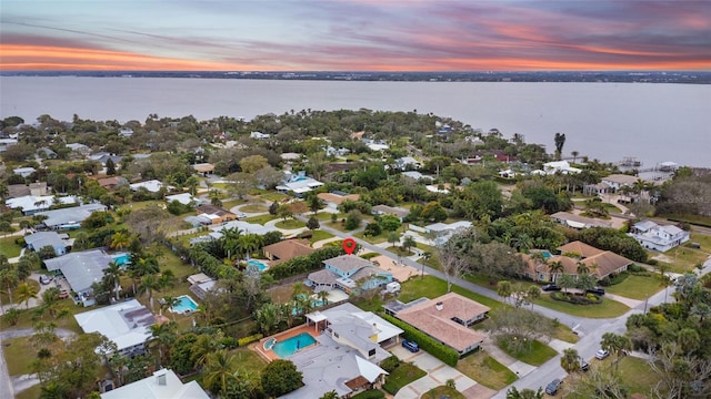 aerial view at dusk with a water view