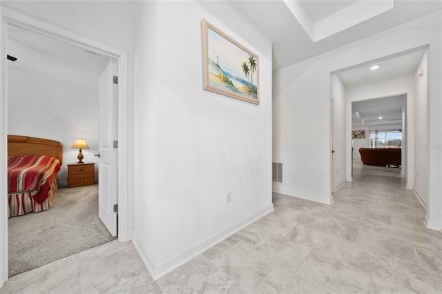 hallway with light colored carpet