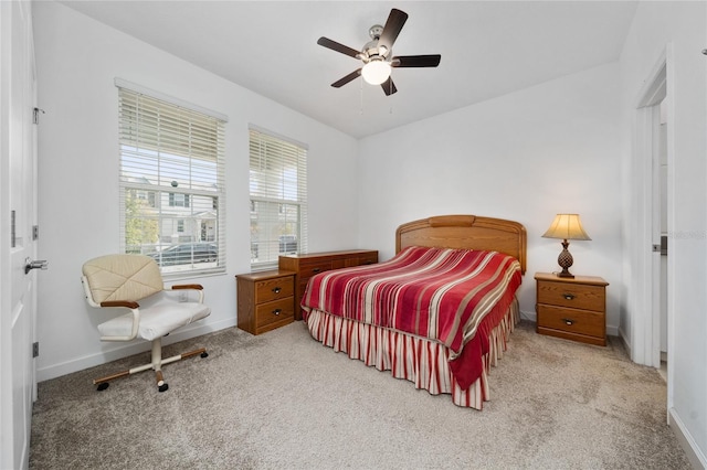 bedroom featuring ceiling fan and light carpet