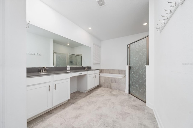 bathroom featuring shower with separate bathtub and vanity