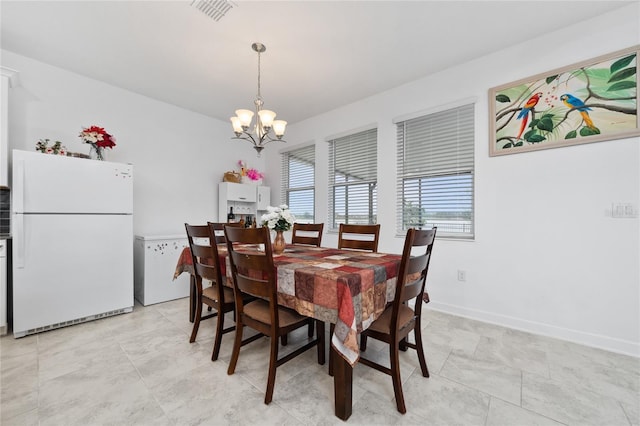 dining space featuring a chandelier