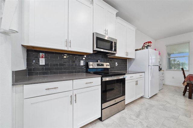 kitchen with white cabinets, appliances with stainless steel finishes, and backsplash