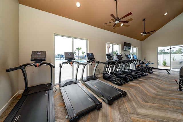 workout area featuring high vaulted ceiling and ceiling fan