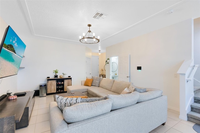 living room featuring light tile patterned flooring and a chandelier