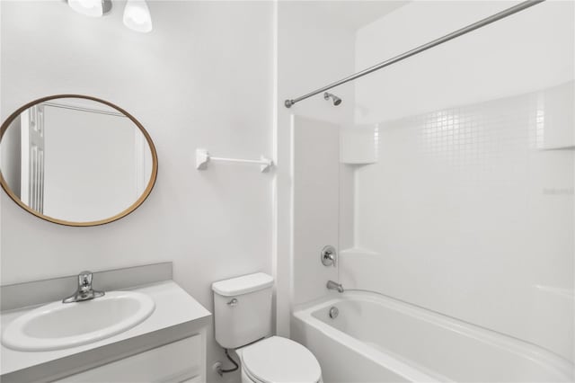 bathroom featuring toilet, shower / bathing tub combination, and vanity