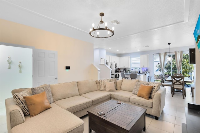 living room with an inviting chandelier, light tile patterned floors, visible vents, and recessed lighting