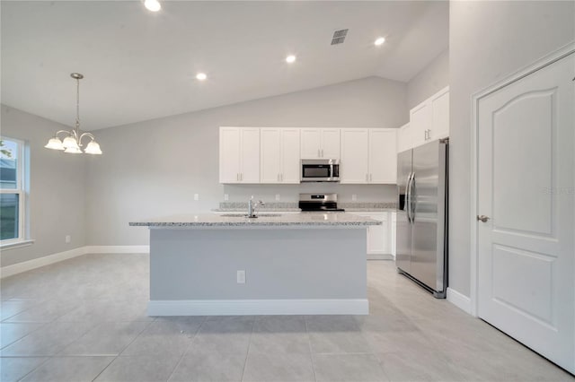 kitchen featuring white cabinets, appliances with stainless steel finishes, light stone countertops, and sink