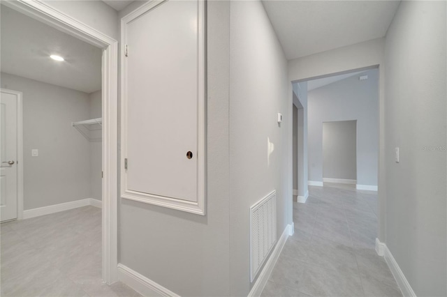 corridor with light tile patterned floors