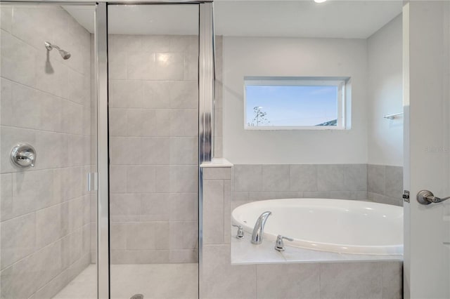 bathroom featuring separate shower and tub