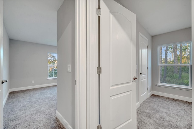 corridor featuring light colored carpet