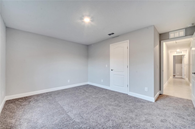 unfurnished bedroom featuring light colored carpet and a closet