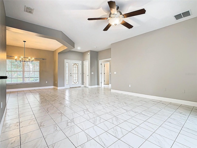 unfurnished room featuring ceiling fan with notable chandelier