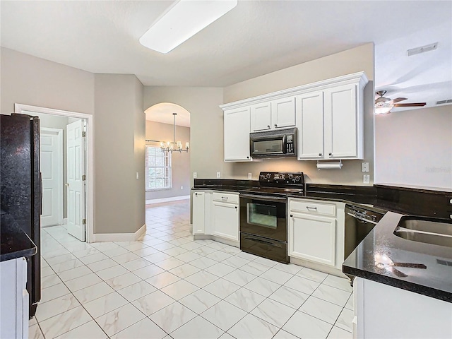 kitchen featuring black appliances, white cabinetry, and sink