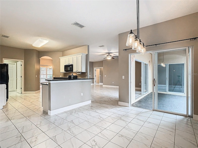 kitchen featuring white cabinets, ceiling fan, black appliances, and pendant lighting