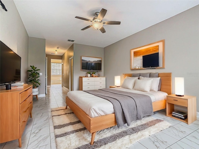 bedroom with ceiling fan and connected bathroom