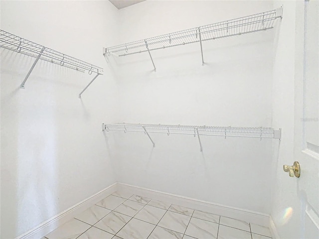 spacious closet featuring tile patterned flooring