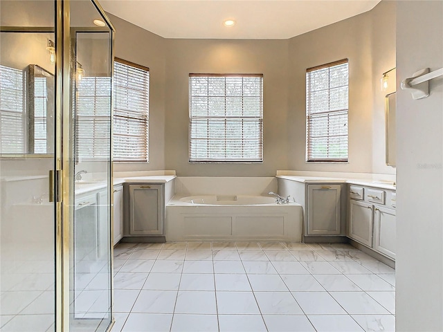 bathroom featuring shower with separate bathtub, vanity, and tile patterned floors