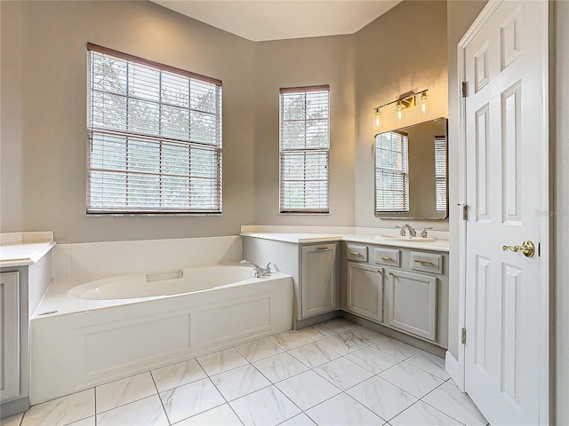 bathroom with vanity and a bath