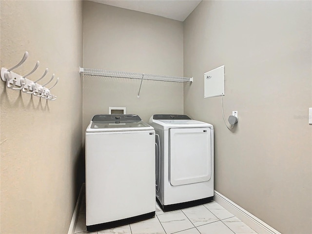 clothes washing area featuring washer and clothes dryer