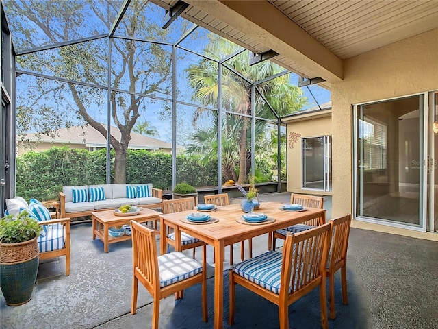 sunroom featuring beam ceiling