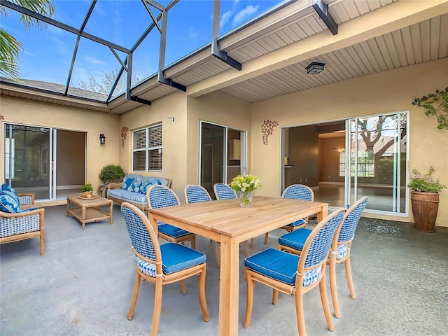 view of patio with glass enclosure and an outdoor living space