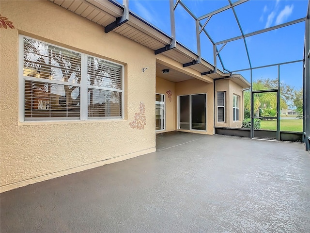 unfurnished sunroom featuring beam ceiling