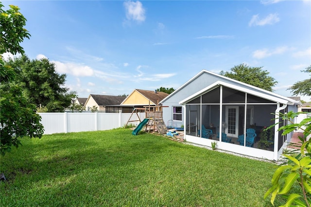 view of yard with a sunroom and a playground