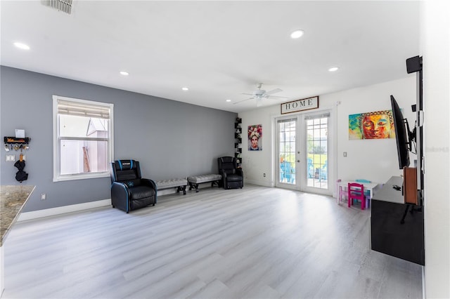 sitting room with ceiling fan, french doors, and light hardwood / wood-style floors