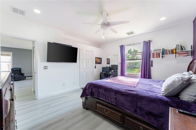 bedroom with light hardwood / wood-style flooring and ceiling fan