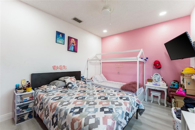 bedroom featuring light wood-type flooring and ceiling fan