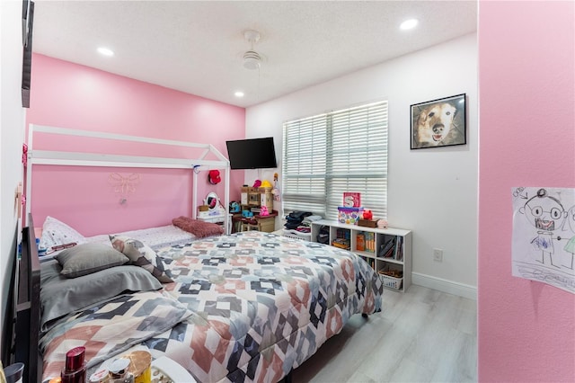 bedroom featuring light wood-type flooring and ceiling fan