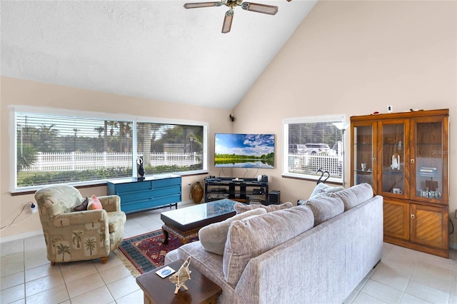 tiled living room featuring ceiling fan and lofted ceiling