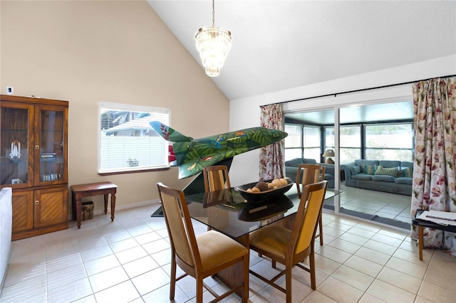 tiled dining space featuring vaulted ceiling and an inviting chandelier