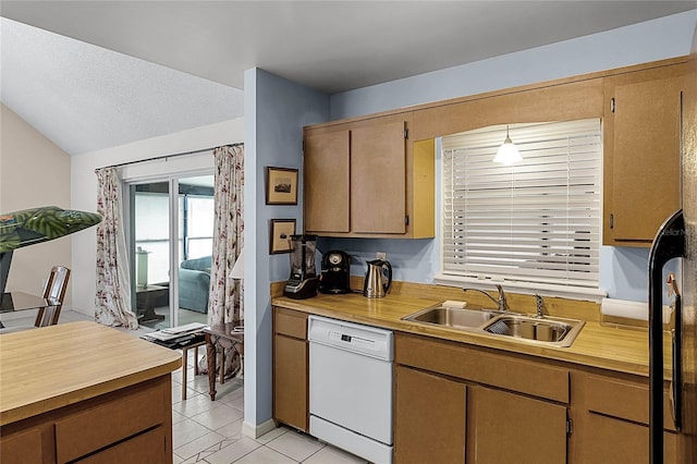 kitchen with white dishwasher, vaulted ceiling, sink, decorative light fixtures, and light tile patterned flooring