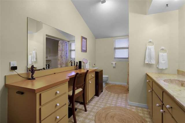 bathroom with vanity, vaulted ceiling, and toilet