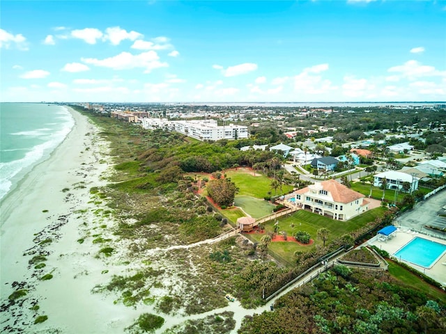 bird's eye view with a water view and a beach view