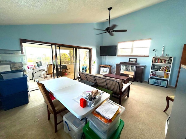 carpeted living room featuring ceiling fan, a textured ceiling, and high vaulted ceiling