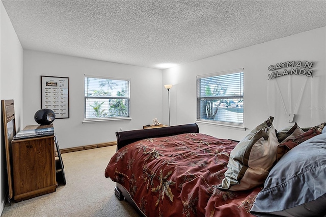 carpeted bedroom featuring a textured ceiling