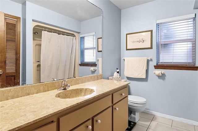 bathroom featuring toilet, vanity, and tile patterned floors