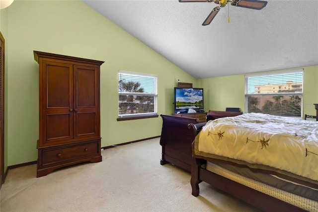 carpeted bedroom featuring a textured ceiling, vaulted ceiling, and ceiling fan