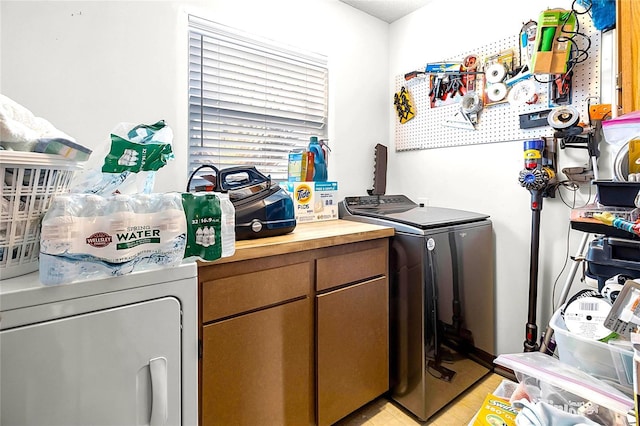 laundry area featuring cabinets and separate washer and dryer