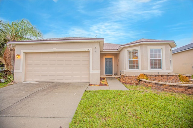 view of front of property with a front lawn and a garage