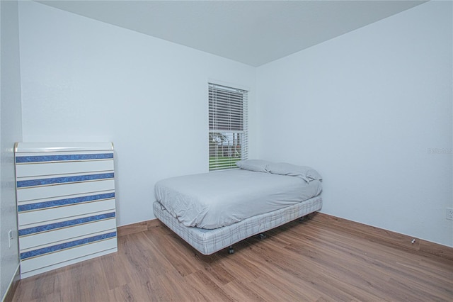 bedroom with wood-type flooring