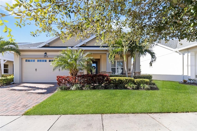 view of front of house with a front yard and a garage