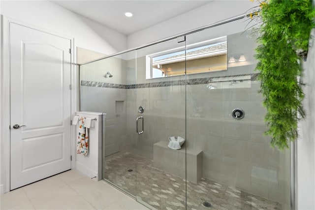 bathroom with tile patterned floors and a shower with shower door