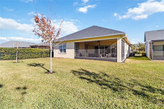 rear view of property featuring a lawn